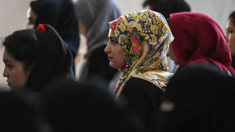 Women are being beaten up by the Taliban in front of the Kardan University in Kabul